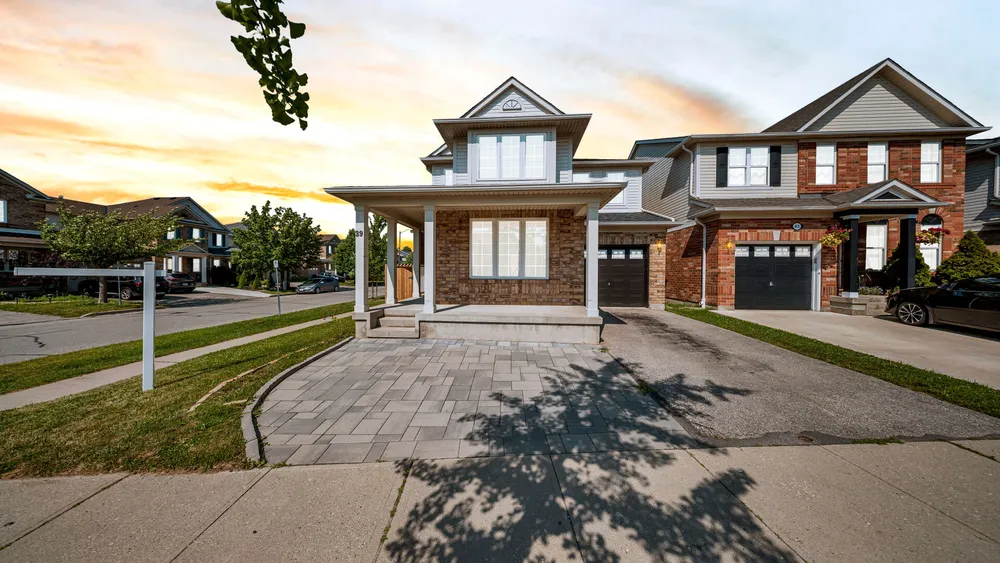 Sunset exterior photograph of a detached home in Cambridge, Ontario